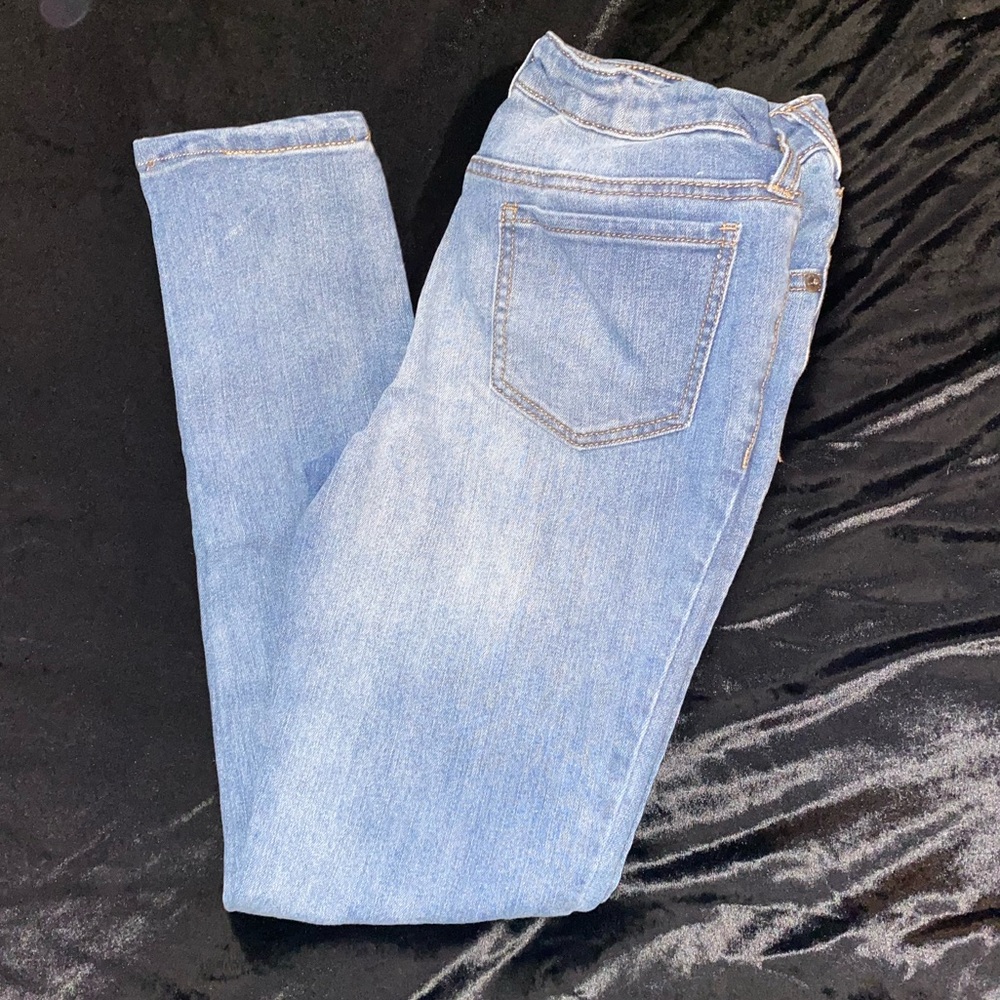 Girl’s skinny jeans with cat faces at the knee